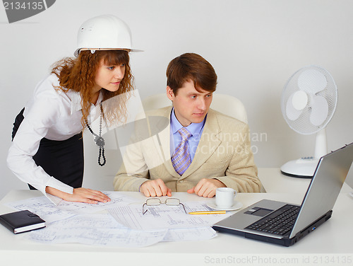 Image of Business construction industry team looking on laptop