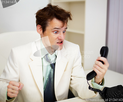 Image of Very angry businessman in office