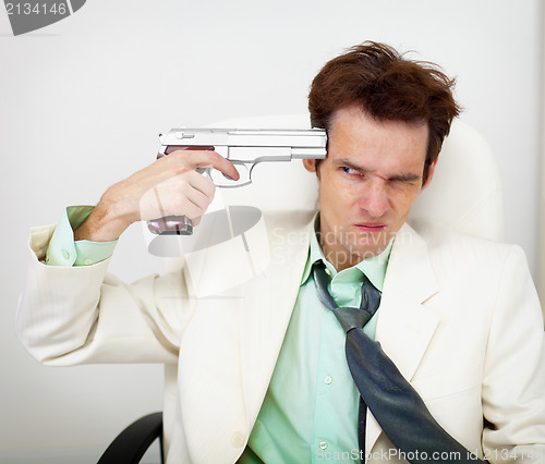 Image of Tattered businessman in white suit with gun