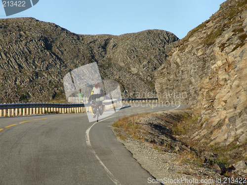 Image of Lonely cyclist in a wasteland