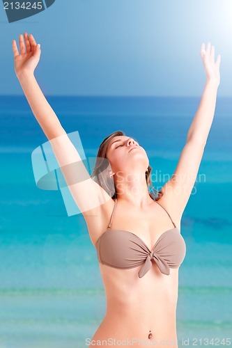 Image of Woman Stretching at the Beach