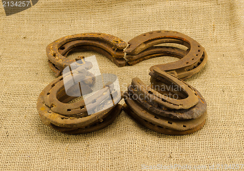 Image of concept clover retro horseshoes linen background 