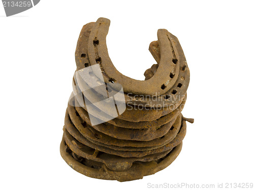 Image of stack rusty retro horseshoes isolated on white 