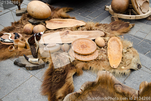 Image of decorative trays bowls cups of wood on bear fur 