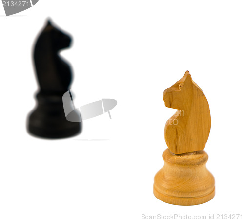 Image of white chess knight figure blurr black horse white 