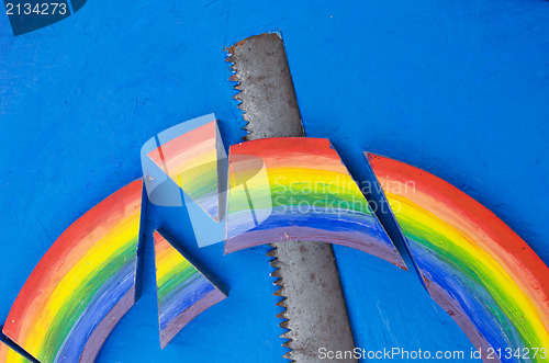 Image of colorful rainbow hand saw blue background concept 