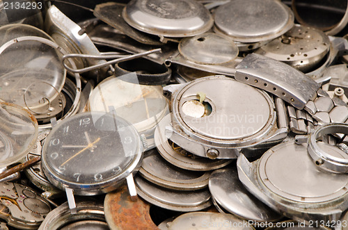 Image of retro old watches clocks parts pile heap closeup 