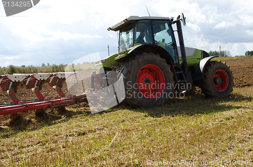 Image of tractor closeup plow furrow agriculture field 