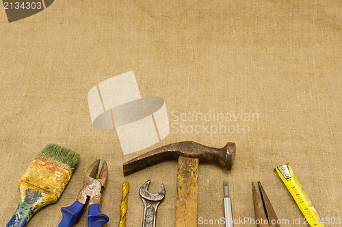 Image of different retro construction work tools on linen 