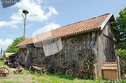 Image of retro carriage wheel barn house bench stork nest 