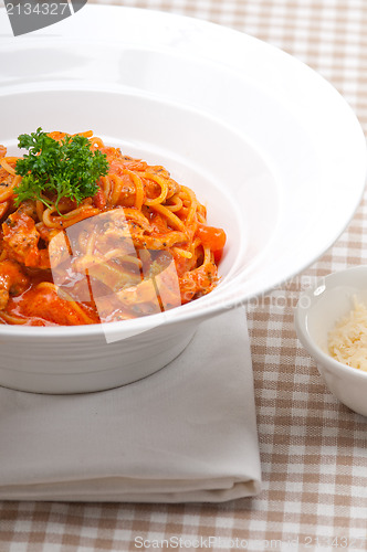 Image of Italian spaghetti pasta with tomato and chicken