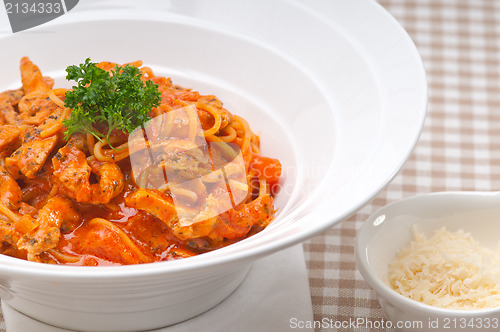Image of Italian spaghetti pasta with tomato and chicken