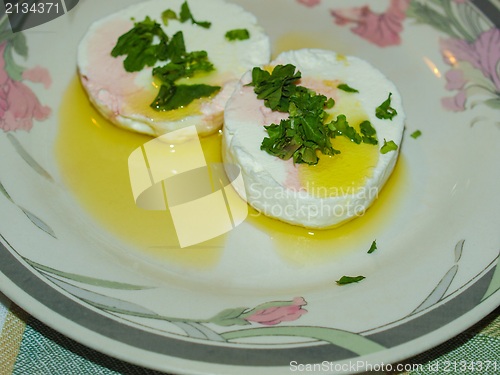Image of Tomino cheese with rucola and olive oil