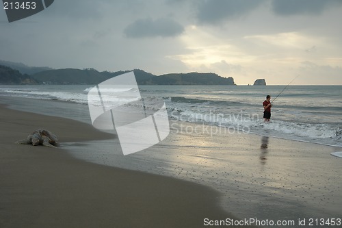 Image of the fisherman. sunset on pacific ocean