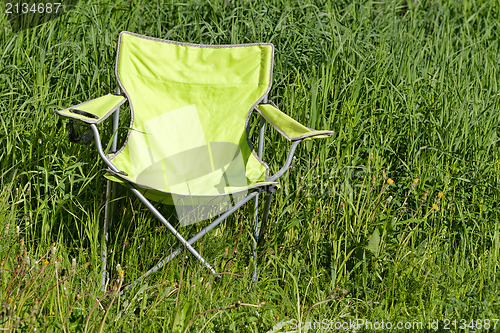 Image of Green folding chair on the grass