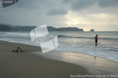 Image of the fisherman. sunset on pacific ocean