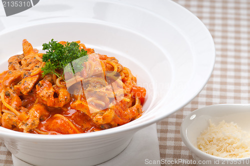 Image of Italian spaghetti pasta with tomato and chicken