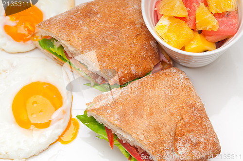 Image of ciabatta panini sandwich eggs tomato lettuce