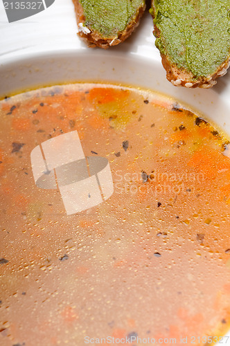 Image of Italian minestrone soup with pesto crostini on side