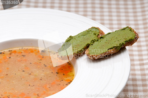 Image of Italian minestrone soup with pesto crostini on side