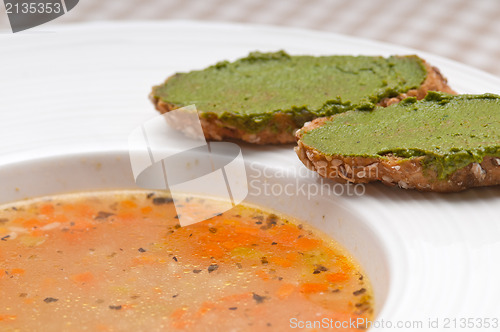 Image of Italian minestrone soup with pesto crostini on side