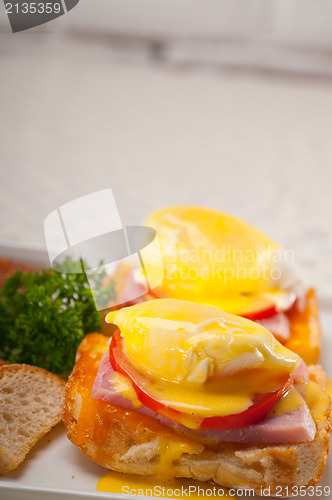 Image of eggs benedict on bread with tomato and ham