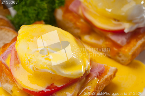 Image of eggs benedict on bread with tomato and ham