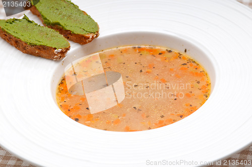 Image of Italian minestrone soup with pesto crostini on side