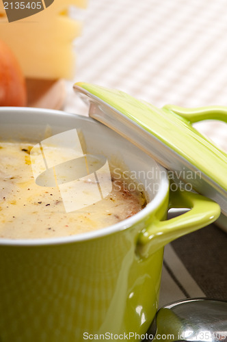 Image of oinion soup with melted cheese and bread on top