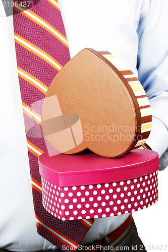 Image of Businessman hiding a gift