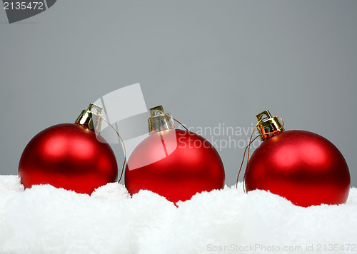 Image of Red christmas balls and snow 