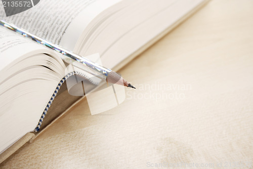 Image of Open book and a pen