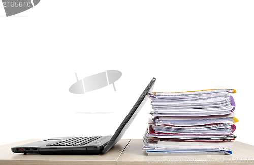 Image of Many files and a computer on a desk 