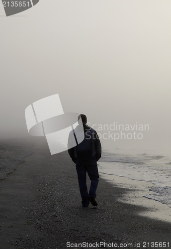 Image of Lonely man walking on a beach