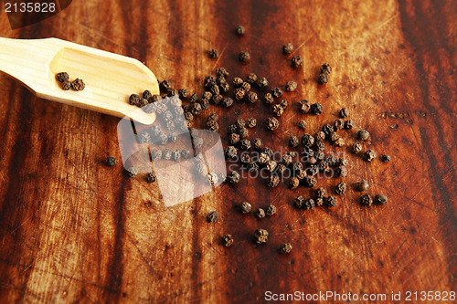 Image of Pepper grains and wooden spoon