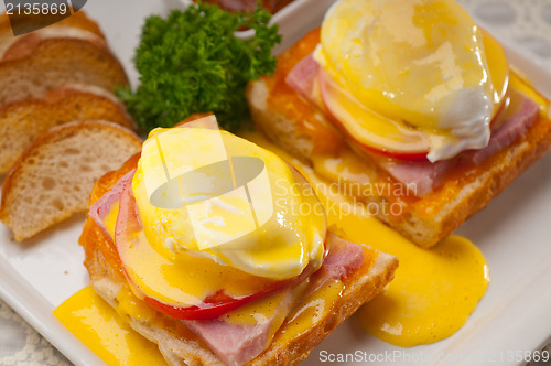 Image of eggs benedict on bread with tomato and ham