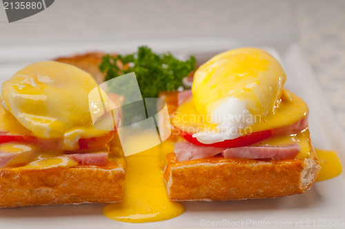 Image of eggs benedict on bread with tomato and ham