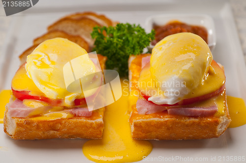 Image of eggs benedict on bread with tomato and ham