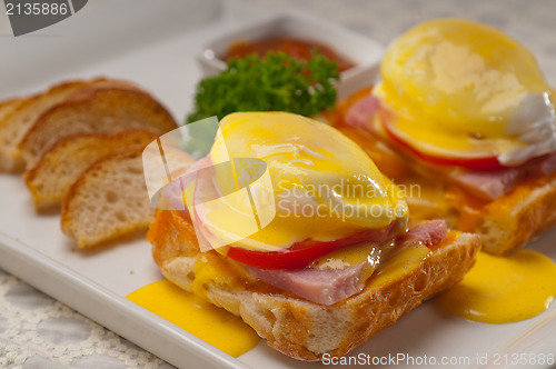 Image of eggs benedict on bread with tomato and ham