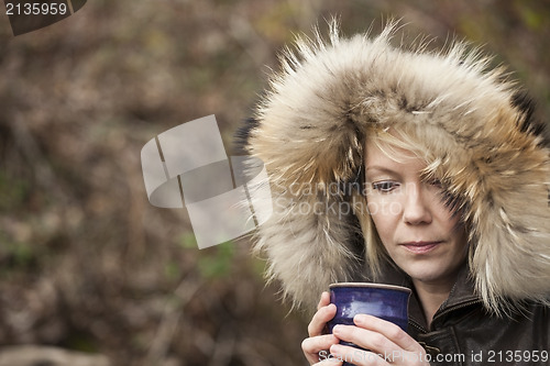 Image of Blonde Woman with Beautiful Blue Eyes Drinking Coffee