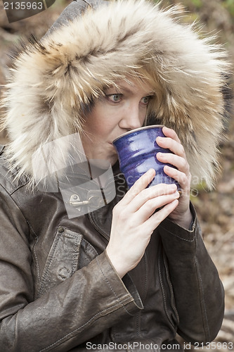 Image of Blonde Woman with Beautiful Blue Eyes Drinking Coffee