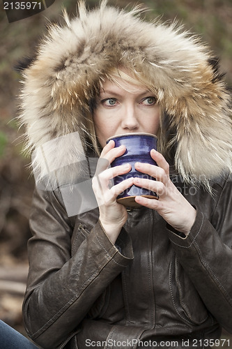 Image of Blonde Woman with Beautiful Blue Eyes Drinking Coffee