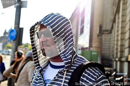 Image of Middle age traveling man wearing hood