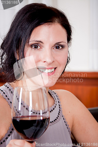 Image of couple drinking red wine in restaurant