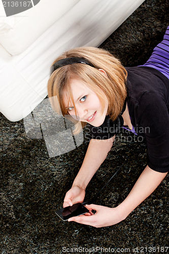 Image of happy teenager girl listening to music
