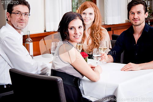 Image of smiling happy people in restaurant