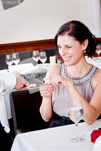 Image of dinner in restaurant man and woman pay by credit card