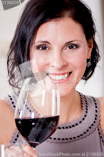 Image of couple drinking red wine in restaurant