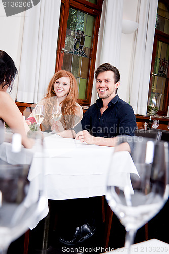 Image of smiling happy people in restaurant
