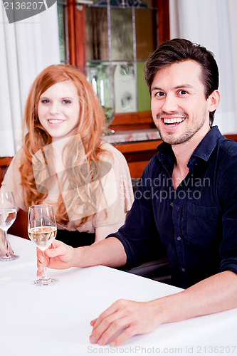 Image of smiling happy people in restaurant